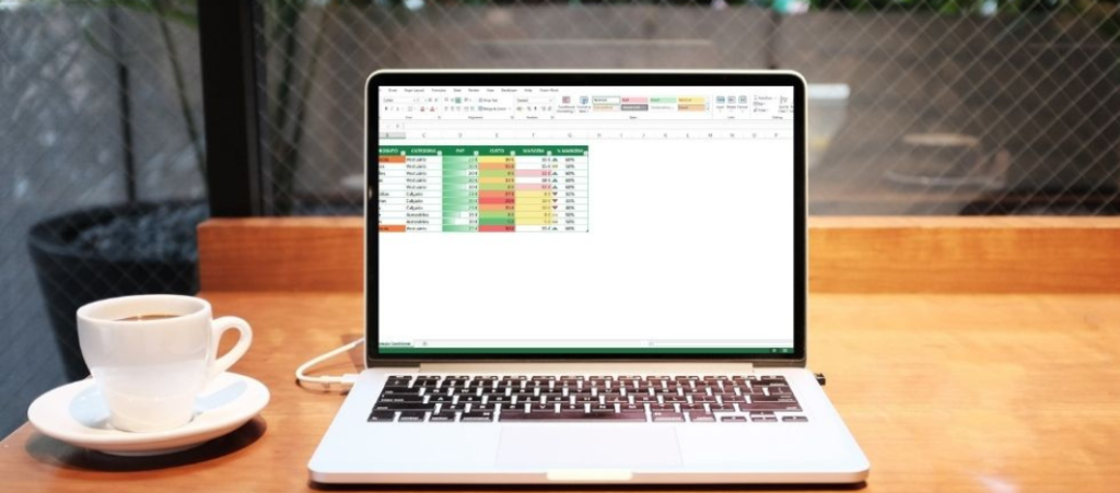 Secretária com computador com Excel com uma tabela personalizada com formatação condicional